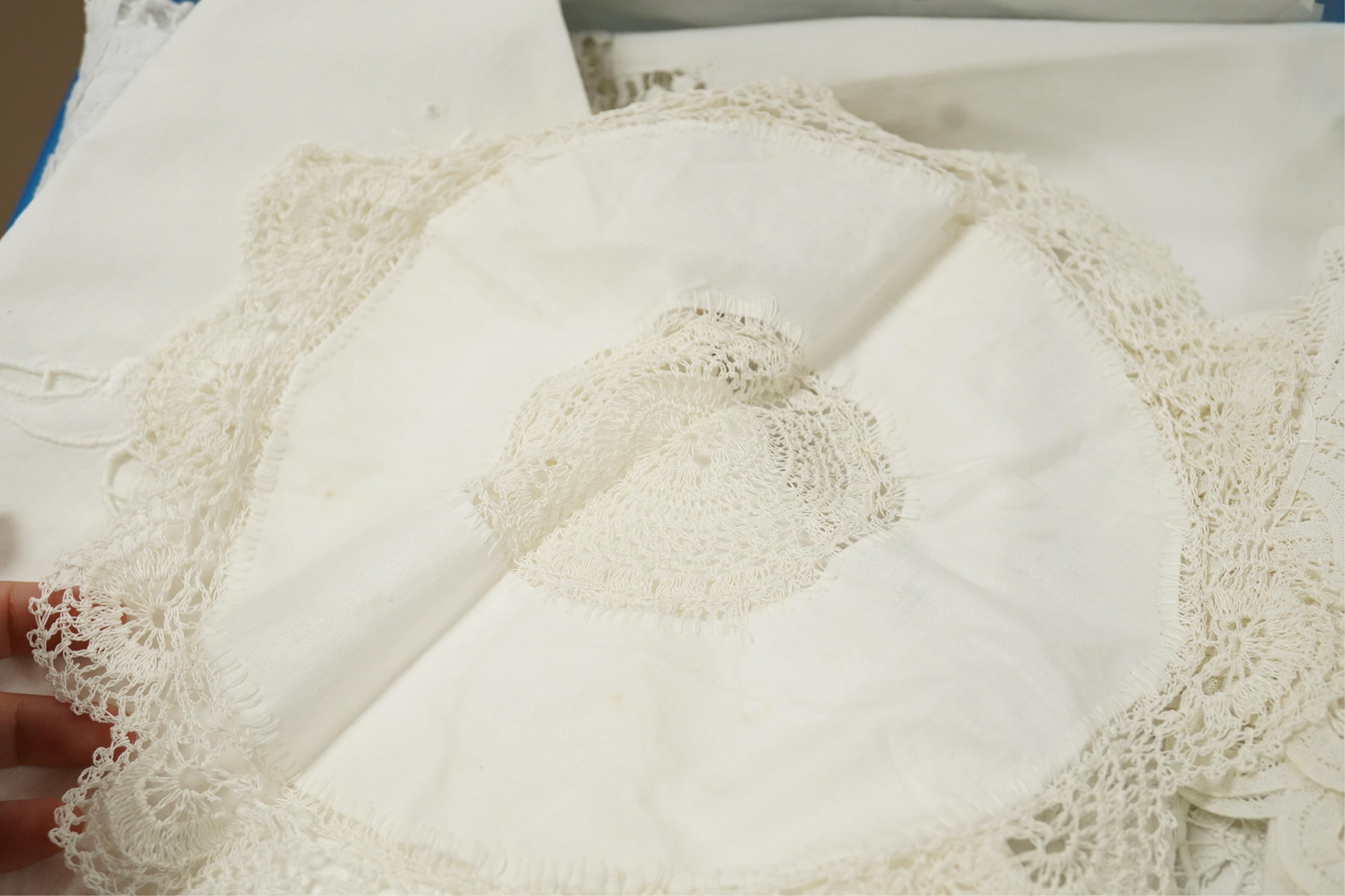A collection of early 20th century and later crochet, cut work and drawn thread table linens and a large embroidered table cloth